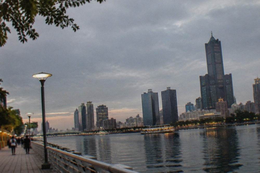 Kaohsiung harbor skyline at dusk with the Love River and city towers
