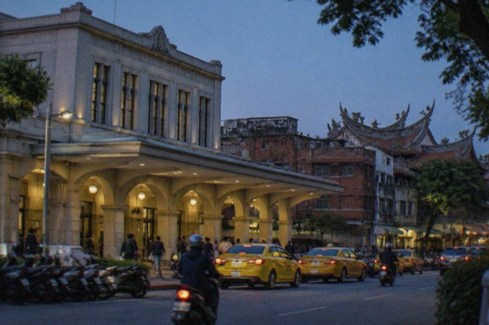 A historic Tainan streetscape with old brick buildings and a temple roofline under a clear sky