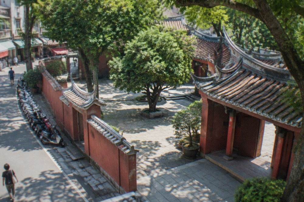 Courtyard of the Tainan Confucius Temple with stone paving and traditional red walls