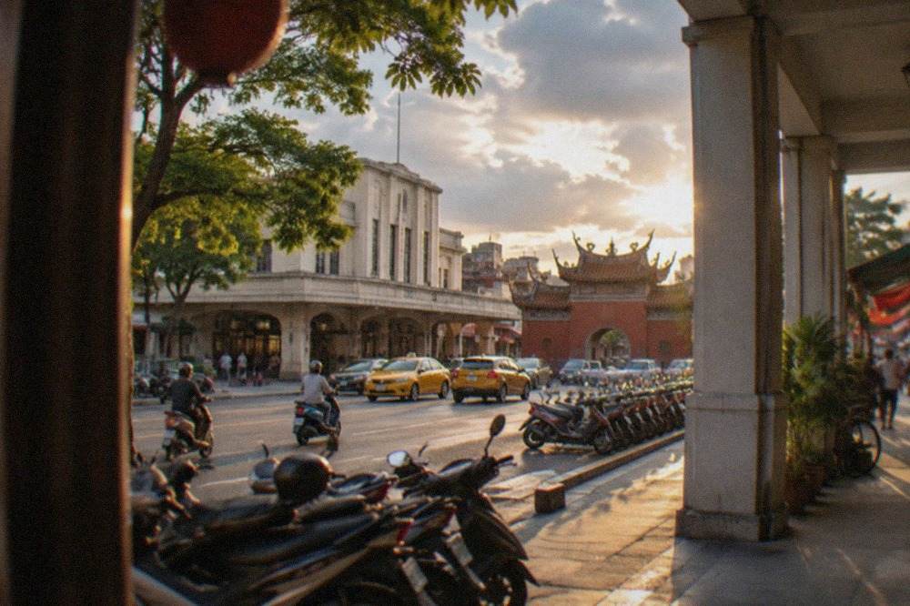 Historic red-brick gateway and old street in Tainan at golden hour