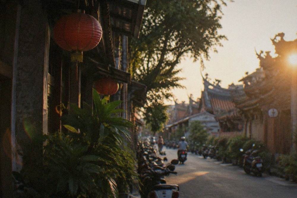 Historic street buildings in Tainan's West Central District under a warm evening sky