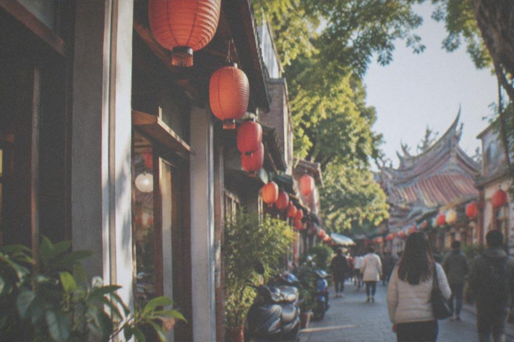 Visitors walking a lantern-lit old street in Tainan on a dry winter evening