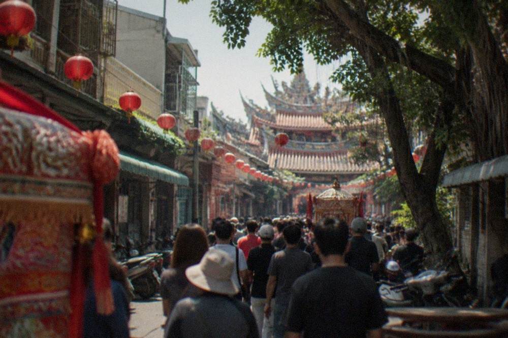 Crowds filling a narrow street at a nighttime festival in Taiwan