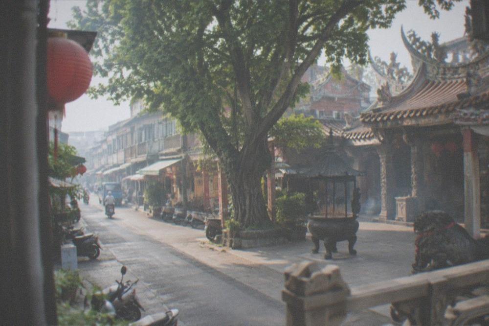 A historic temple courtyard with incense and carved decoration