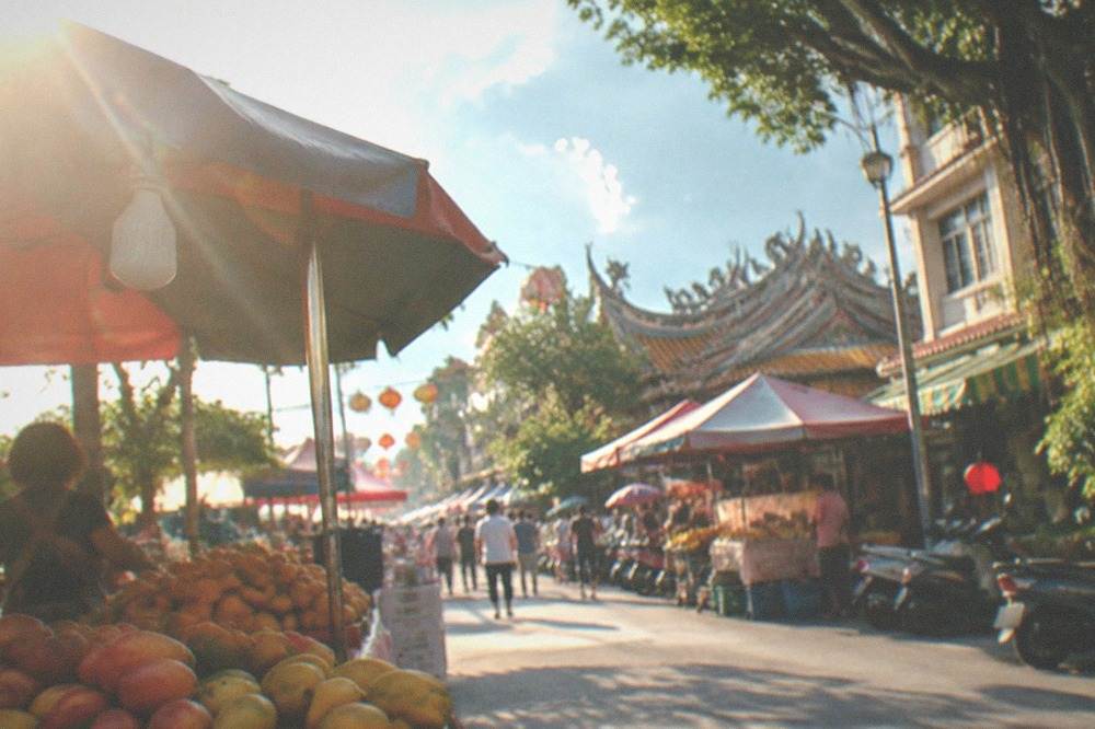 Festival stalls under canopies in a Yujing square during the mango festival