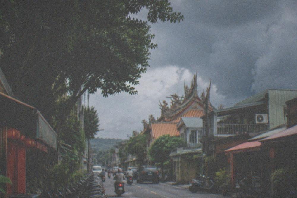 Afternoon storm clouds building over mango orchard hills in summer