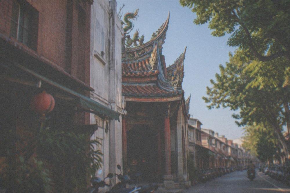 A sunny Tainan street with old brick walls and clear skies in winter