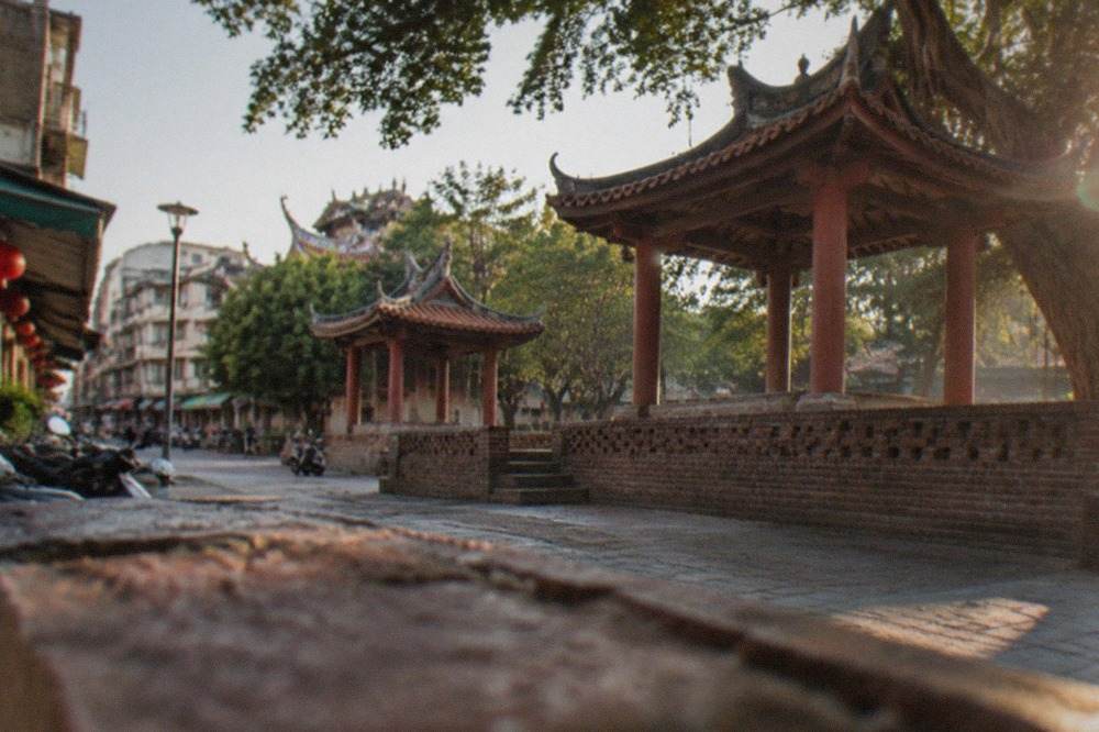 A red-brick tower with Chinese pavilions standing in a plaza in central Tainan