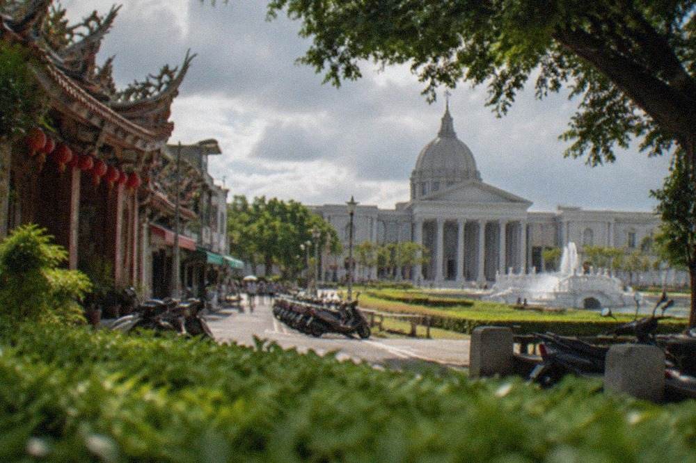 The classical stone facade of the Chimei Museum with its columned entrance and the museum park in front