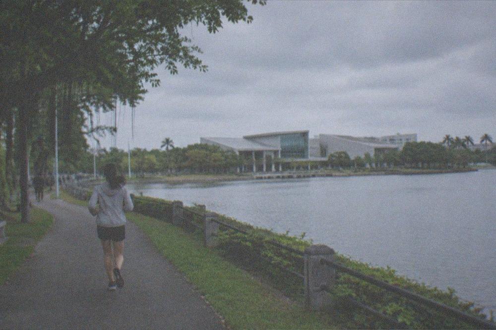 The museum building seen across the lake with lawns and trees of the metropolitan park
