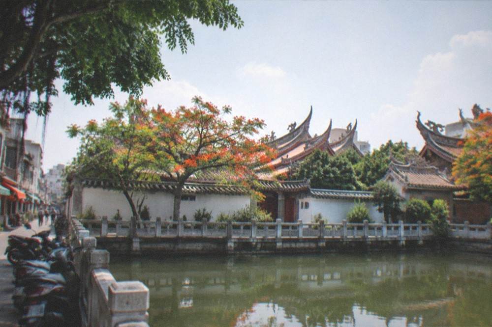 Temple roof ridges in Tainan with curved ornamentation seen from below