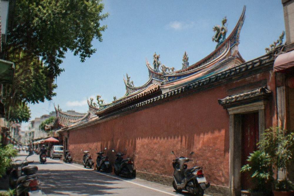 Ornate temple roofline with curved eaves and ceramic decoration against the sky