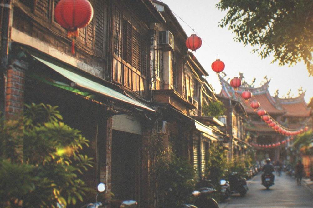 Timber upper-floor facades of old townhouses seen from a narrow lane