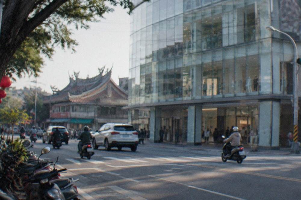 A modern department store exterior on a wide city road in Tainan