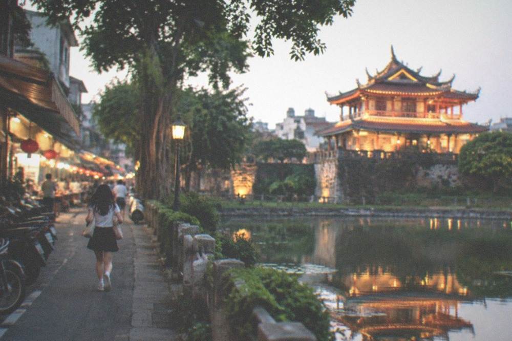 Chihkan Tower lit up at night with its Chinese pavilion reflected in a pond