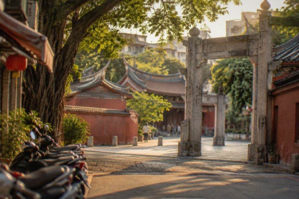 A stone gateway with Chinese calligraphy panels at a temple entrance