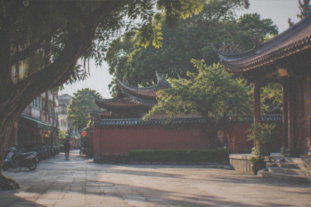 Sunlight falling across a paved temple courtyard in warm weather