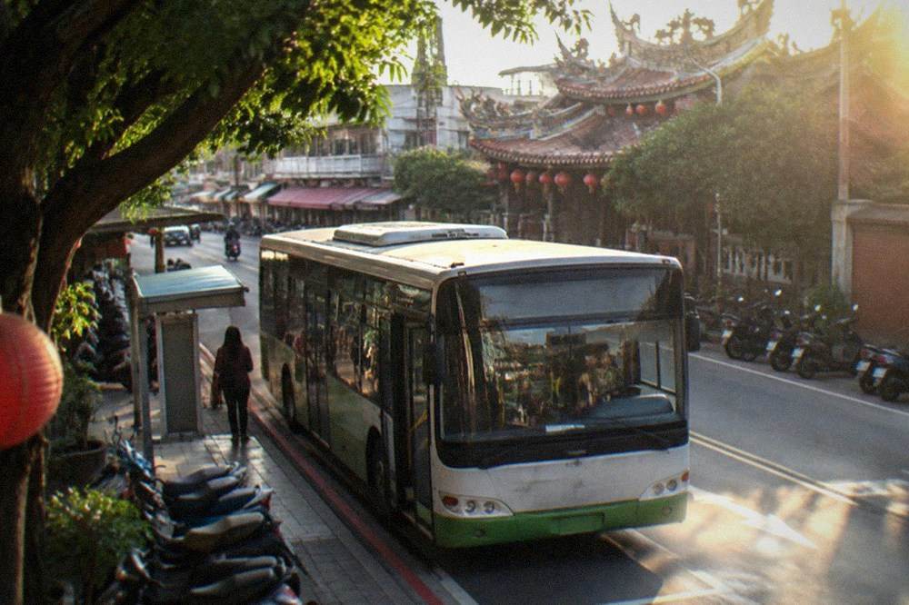 A Taiwan city bus parked at a roadside stop in a small town