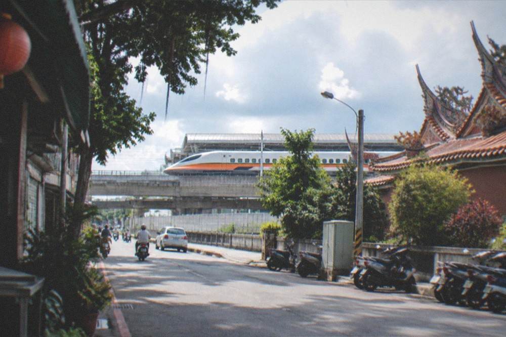 A high speed rail train pulling into a modern station platform in Taiwan