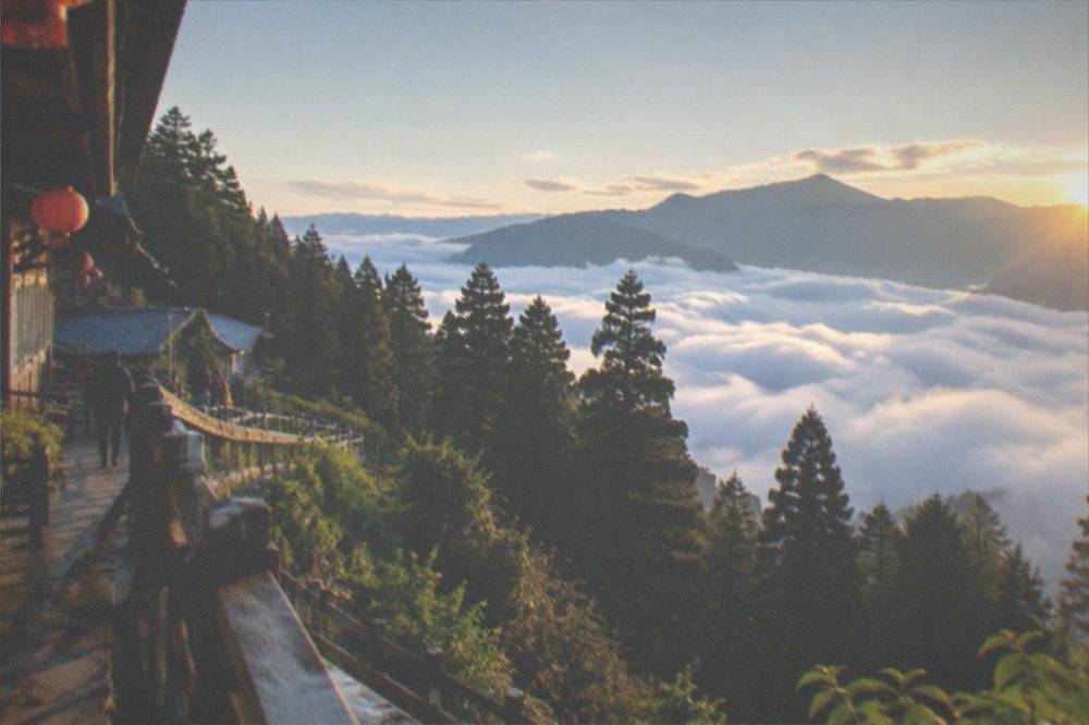 Sunrise light breaking over a sea of clouds filling a mountain valley