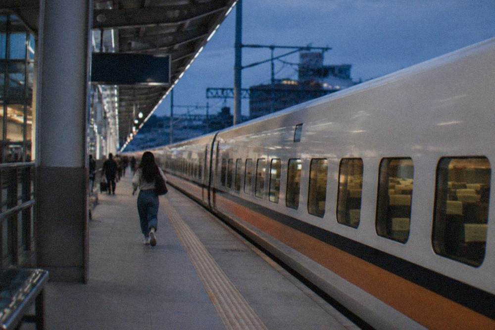 A white high speed train stopped at a modern station platform in Taiwan