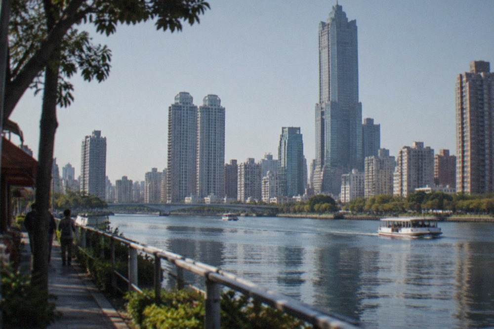 High-rise towers along the Love River waterfront in Kaohsiung under a clear sky