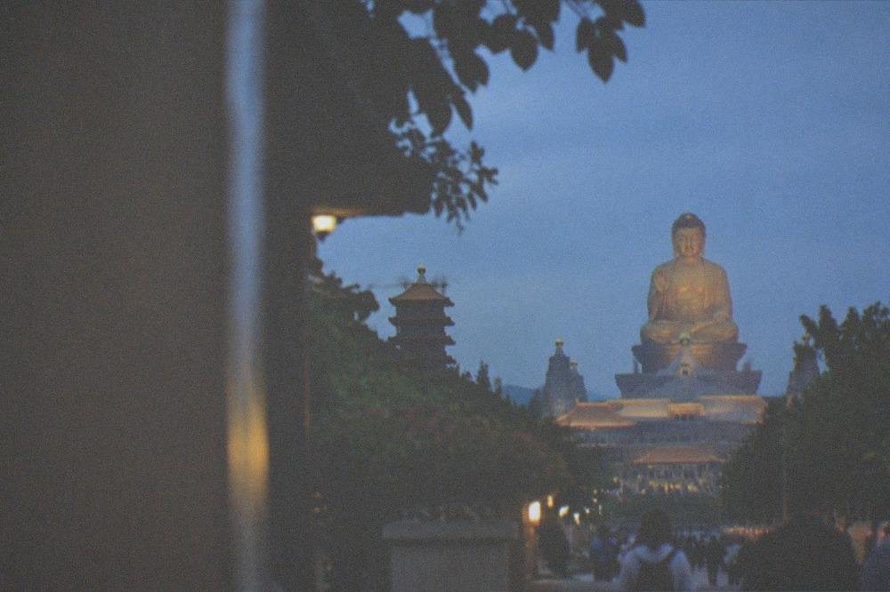 A large golden Buddha statue towering over the monastery buildings at Fo Guang Shan