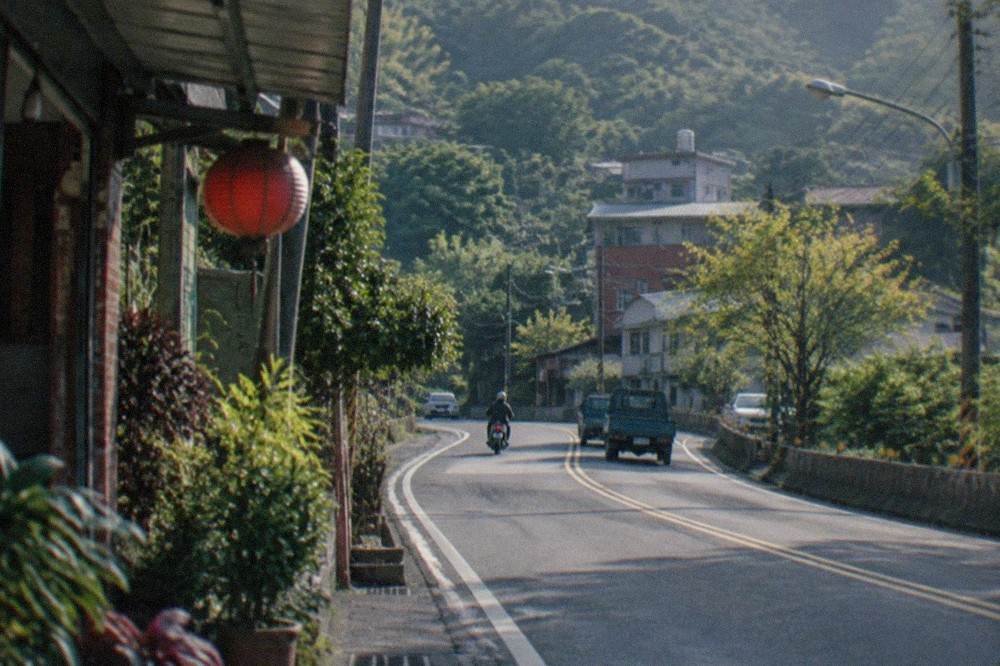 A winding country road through green hills in southern Taiwan