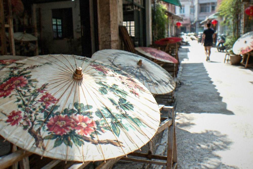 A hand-painted oil-paper umbrella drying in a workshop