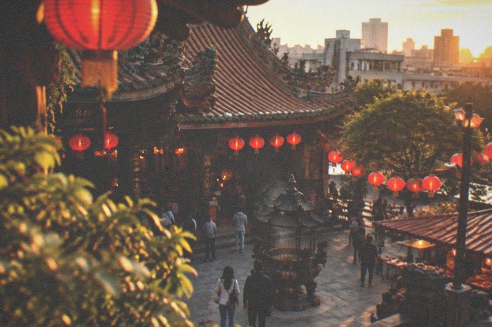 Evening view of a Taiwanese temple courtyard lit by lanterns