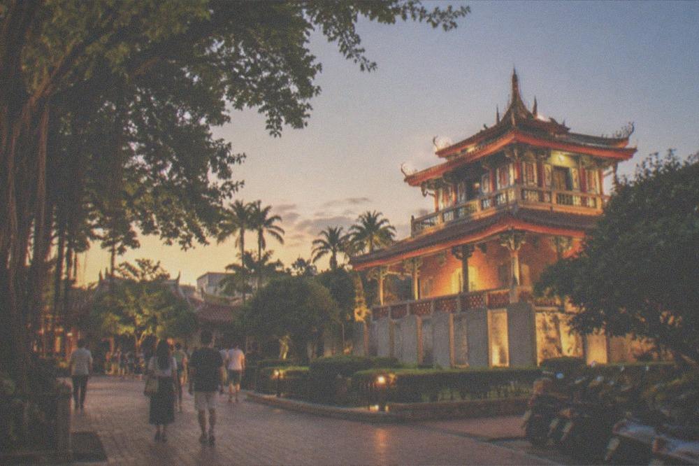 Chihkan Tower lit up at night with visitors walking in the courtyard