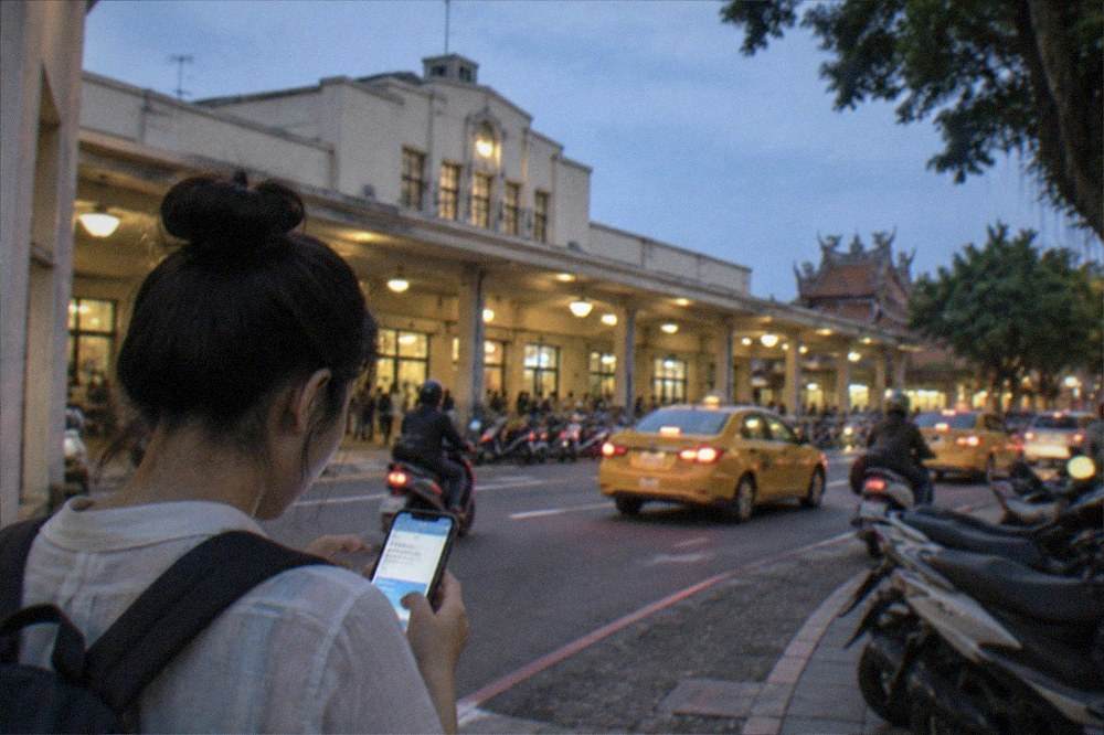 A traveler using a smartphone translation app on a Chinese-language menu at a small eatery
