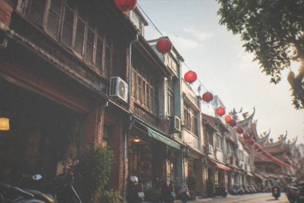 Lanterns and restored low buildings along Shennong Street in Tainan at dusk