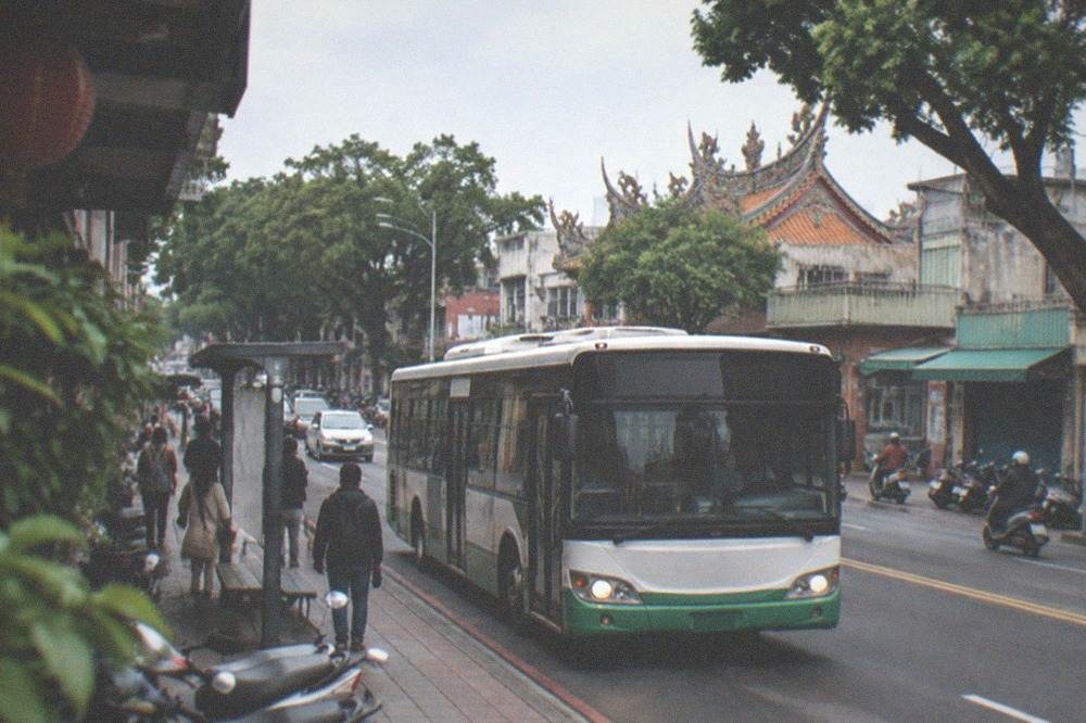 A Tainan city bus at a roadside stop in a busy street