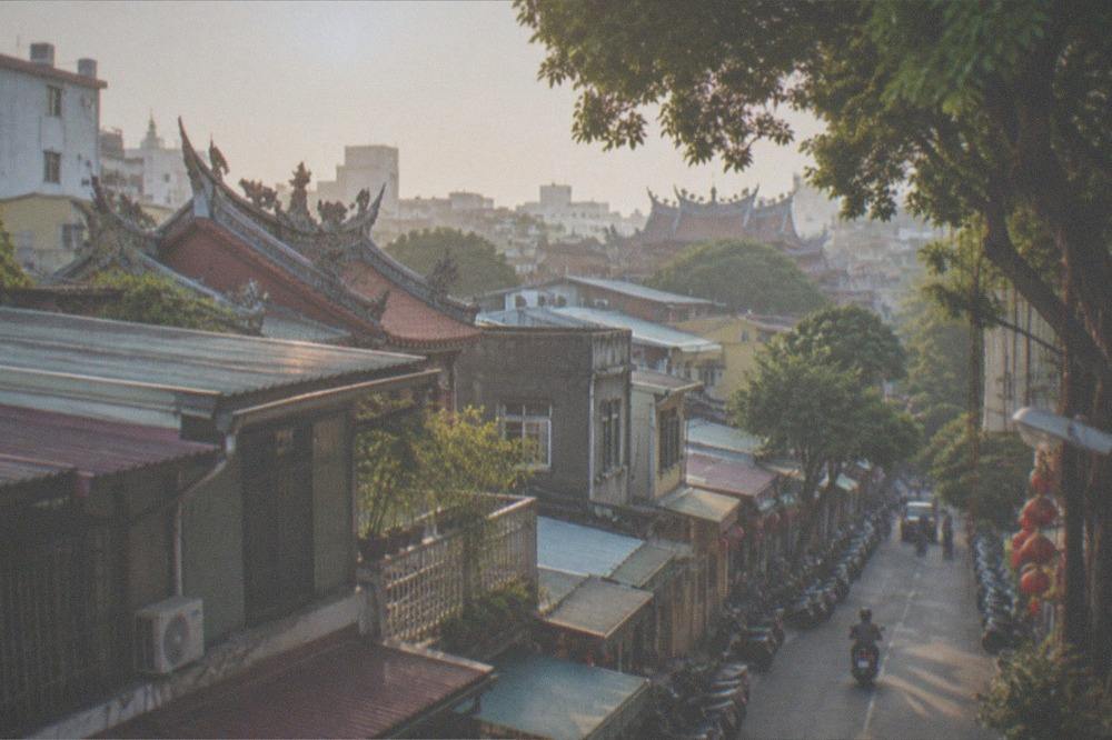 A wide view over Tainan rooftops in warm late afternoon light