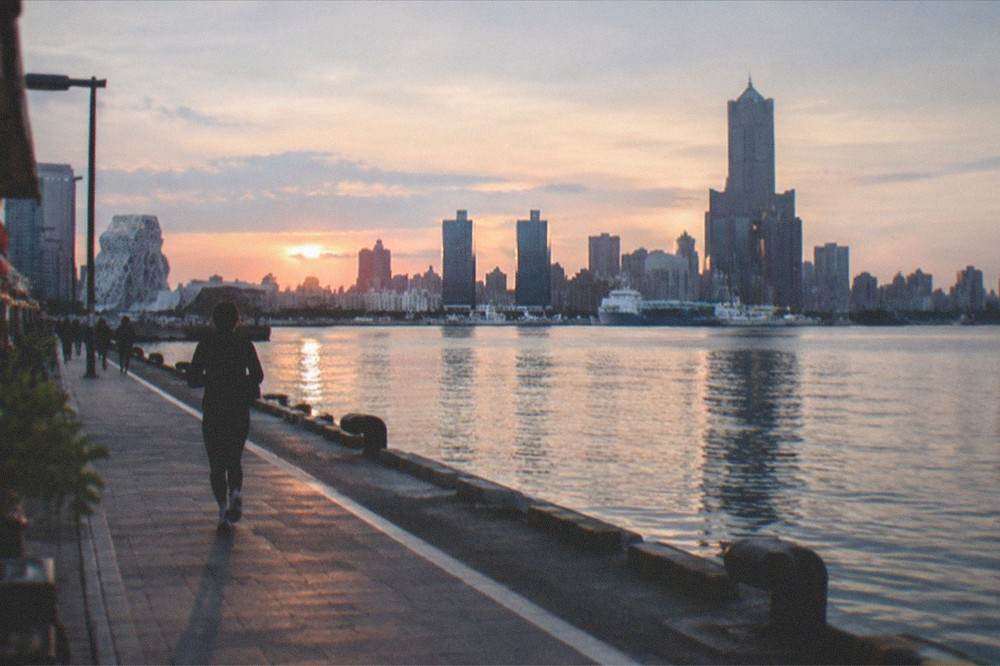 A harbor skyline at dusk in Kaohsiung seen from across the water