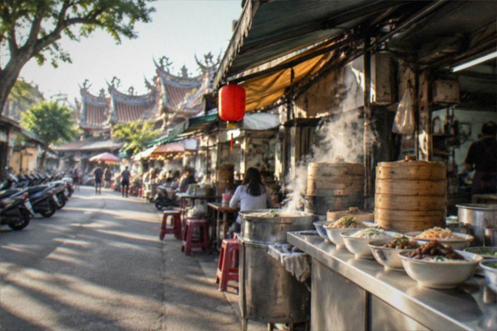 Bowls of different Tainan dishes lined up on a food stall counter