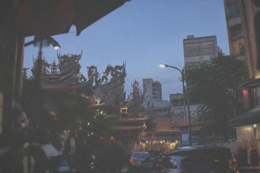 Ornate temple roofline with dragon decorations under a clear sky