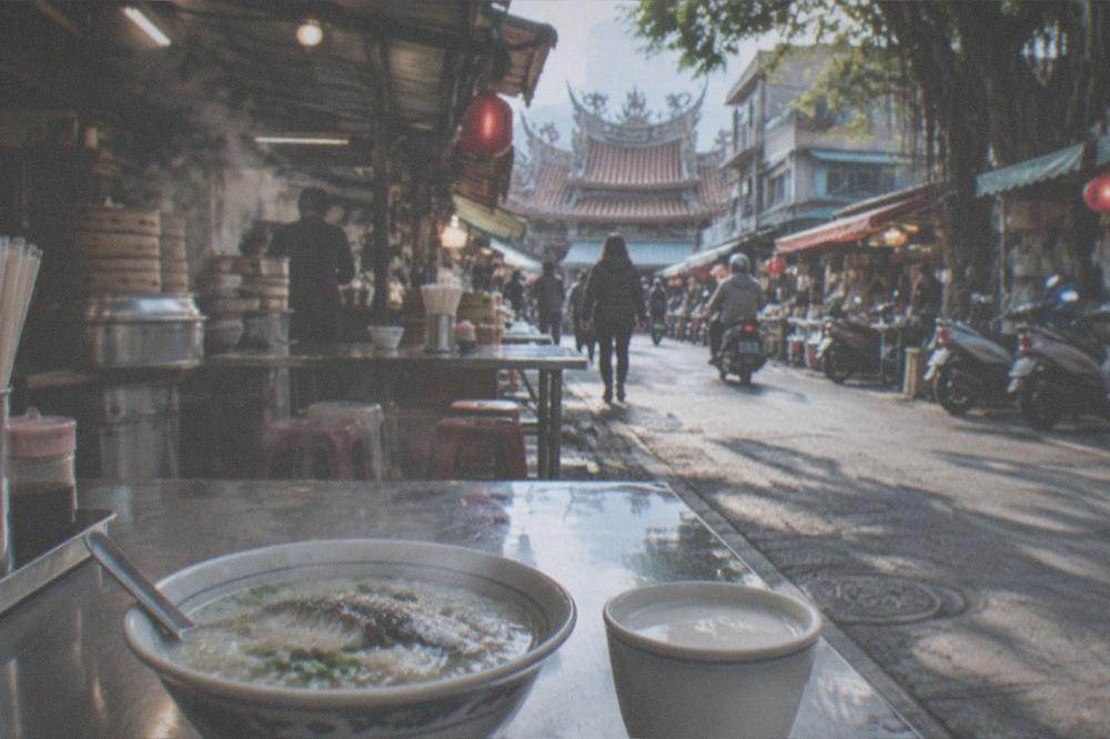 A bowl of milkfish porridge and a cup of warm soy milk on a breakfast table