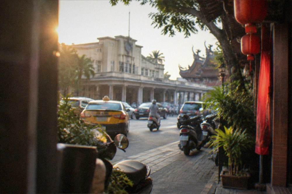 A traditional Tainan street facade with lanterns and a guesthouse entrance