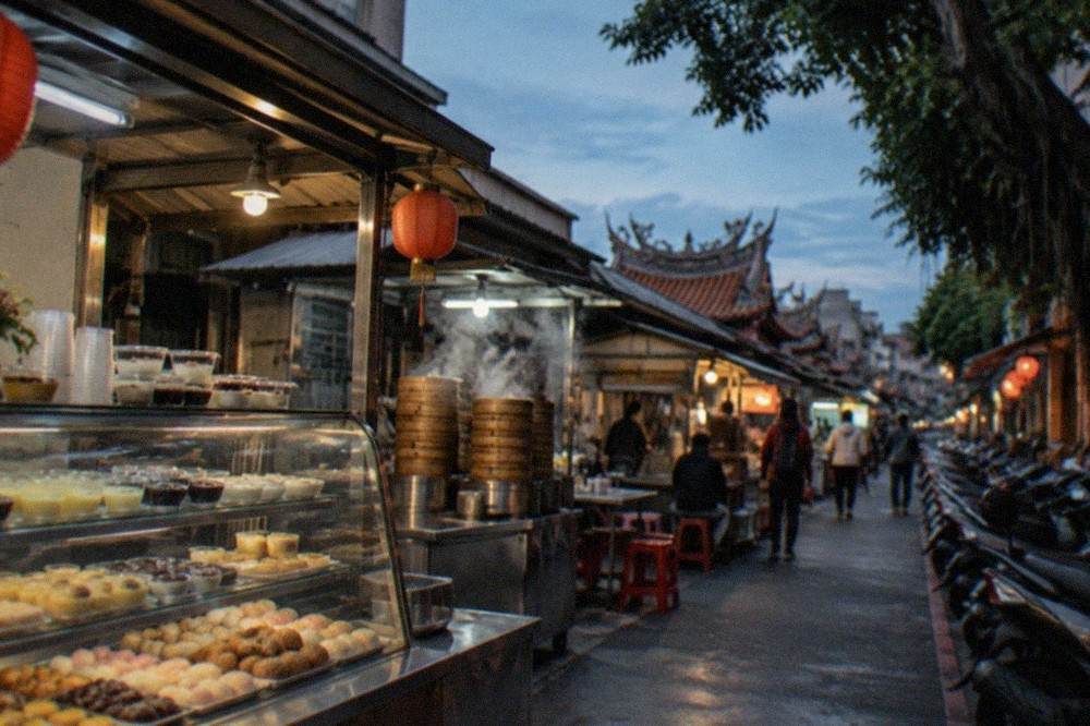 A traditional Taiwanese dessert shop counter with glass cases of sweet pastries and puddings