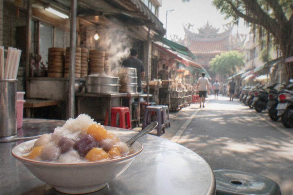 A bowl of taro and sweet potato ball dessert with shaved ice on a cafe table