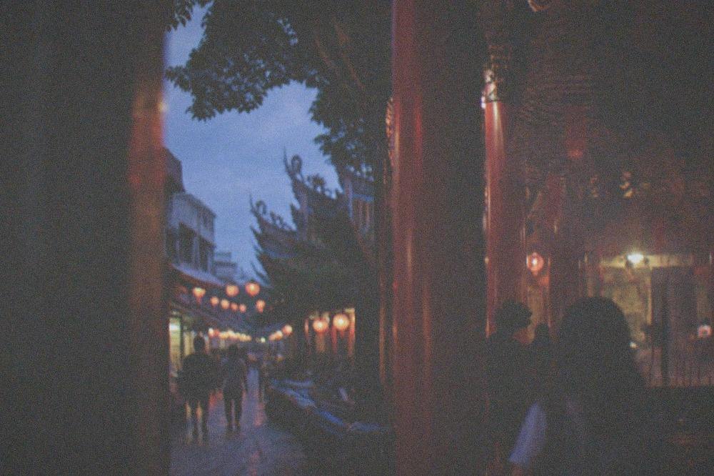 Visitors walking a lantern-lined street in an old Taiwanese town at night