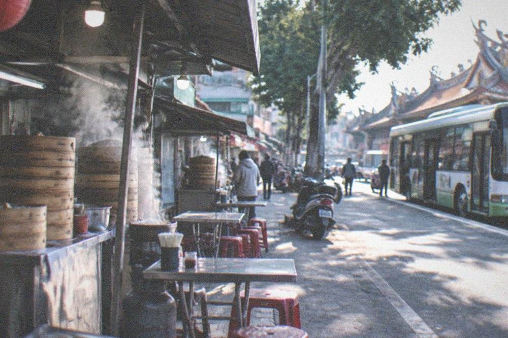 A Tainan city bus at a stop on a sunny street