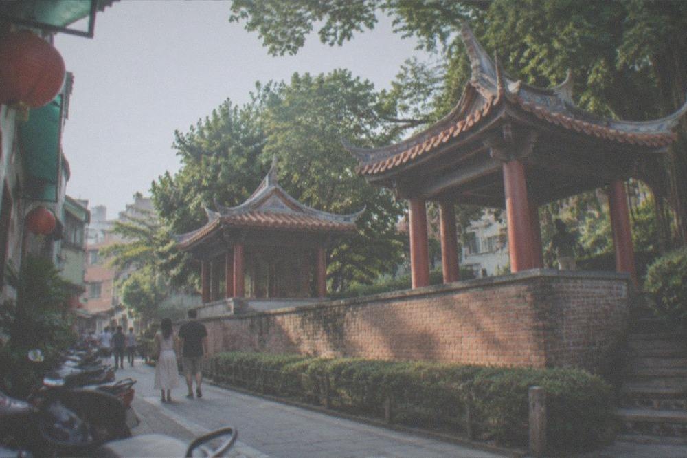 A museum gallery hall with sculpture displays and visitors