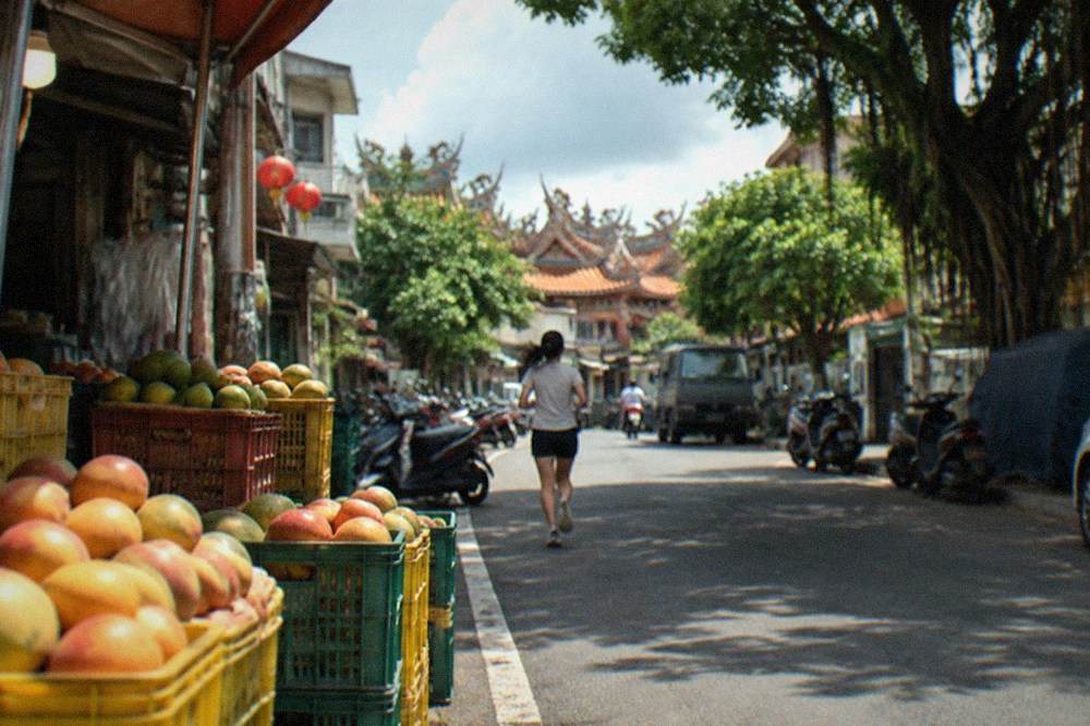 Crates of freshly harvested mangoes stacked at a Yujing roadside stall