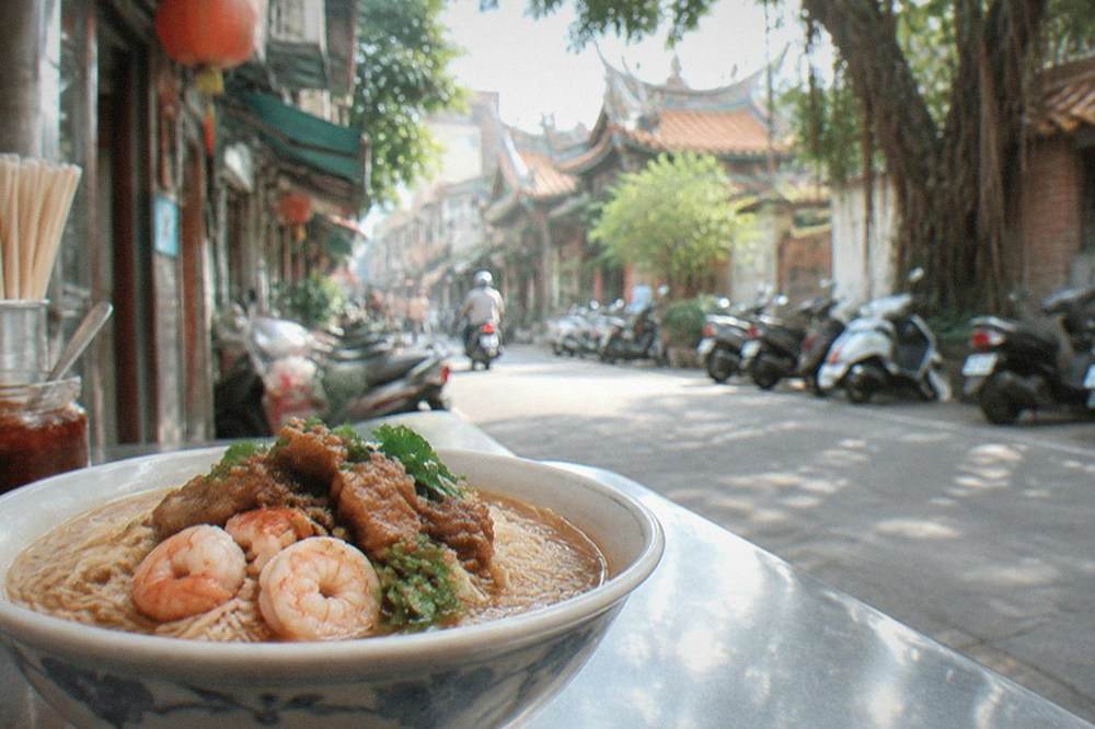 Danzai noodles in a small bowl with shrimp and braised pork topping