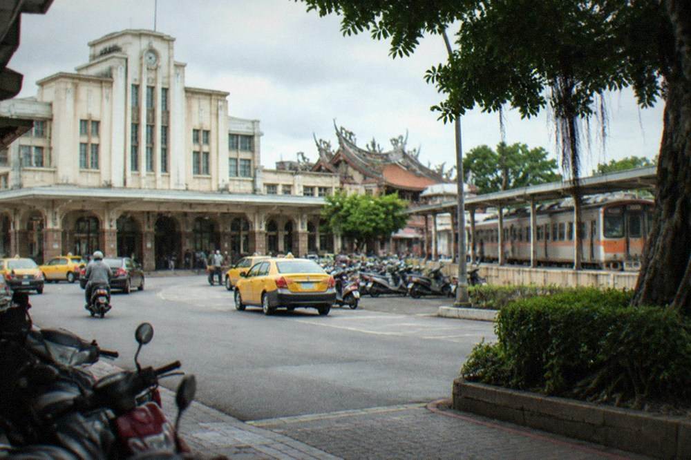 A branch-line train at a small station platform on the way into central Tainan