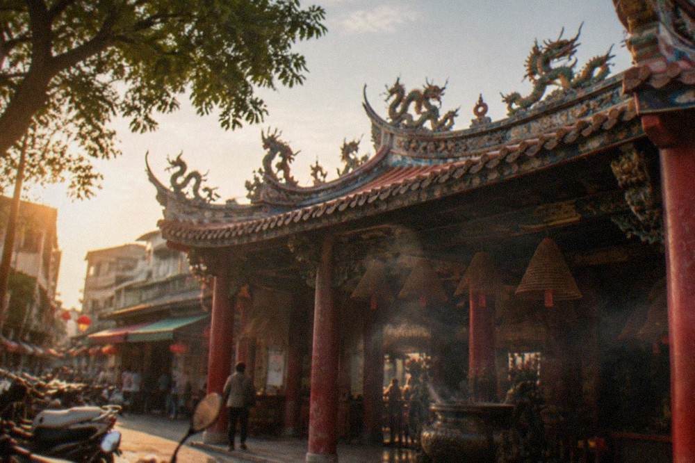 An ornate temple roofline with curved ridges and dragon decorations in Tainan