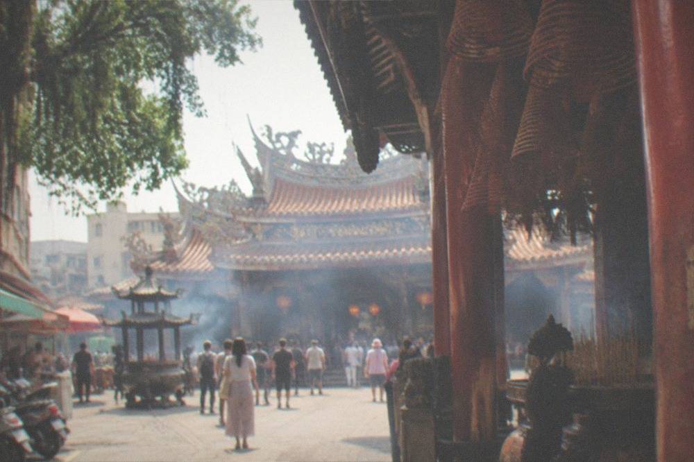 A large Taiwanese temple complex with wide courtyards and crowds of visitors